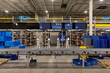 © Raymond Forbes LLC/Stocksy - Production Status Monitors on floor of warehouse