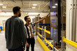 © Raymond Forbes LLC/Stocksy - Manager meets with worker at E-Commerce Warehouse