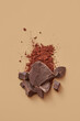 © Yaroslav Danylchenko/Stocksy - Pieces of chocolate and cocoa powder in studio