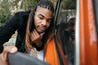 © Luciano Spinelli/Stocksy - Model with dreadlocks look at himself in car mirror