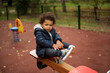 © Jelena Markovic/Stocksy - Toddler playing seesaw