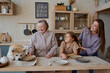 © Tatiana Timofeeva/Stocksy - the family is in the kitchen preparing for dinner.
