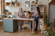 © Tatiana Timofeeva/Stocksy - the family is in the kitchen preparing for dinner.