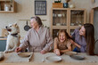 © Tatiana Timofeeva/Stocksy - the family is in the kitchen preparing for dinner.