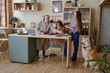 © Tatiana Timofeeva/Stocksy - the family is in the kitchen preparing for dinner.