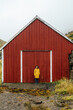 © Kike Arnaiz/Stocksy - Contemplative woman against barn in mountains