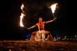 © Igor Kardasov/Stocksy - Latin fireshow performer doing hoko dance