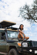© Kike Arnaiz/Stocksy - Arab woman on SUV in safari