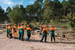 © Ezequiel Giménez/Stocksy - Group of lumberjacks listening to headman