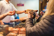 © Irina Efremova/Stocksy - Buying a Christmas Market Bratwurst in a bun
