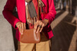© Anna Berkut/Stocksy - mature fashion woman hands opening purse