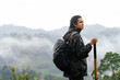 © Kike Arnaiz/Stocksy - Tourist woman trekking in mountains
