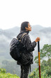 © Kike Arnaiz/Stocksy - Tourist woman trekking in mountains