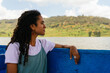 © Kike Arnaiz/Stocksy - Curly woman navigating on a lake with a boat