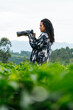 © Kike Arnaiz/Stocksy - Arab female photographer standing in nature