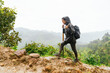 © Kike Arnaiz/Stocksy - Arab female hiking in green mountains