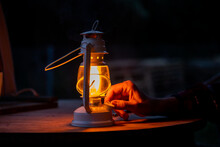 Man Lighting Oil Lamp 