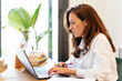 © Manu Padilla/Stocksy - Serious Hispanic researcher typing on laptop