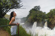© Kike Arnaiz/Stocksy - Happy Arab woman enjoying waterfall