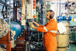 © Igor Kardasov/Stocksy - Marine engineer officer checking vessel engines