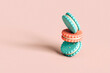 © Giada Canu/Stocksy - Cookies balanced on a pink background with copy space