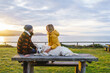 © Daniel Gonzalez/Stocksy - Happy couple with dog on seashore