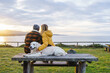 © Daniel Gonzalez/Stocksy - Couple with dog admiring sea