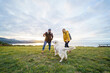 © Daniel Gonzalez/Stocksy - Happy couple playing with dog