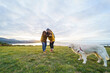© Daniel Gonzalez/Stocksy - Couple taking photo of dog