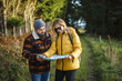 © Daniel Gonzalez/Stocksy - Couple reading map during traveling