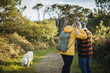 © Daniel Gonzalez/Stocksy - Couple enjoying stroll with dog