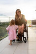© Santi Nuñez/Stocksy - Mother in wheelchair enjoying with her daughter