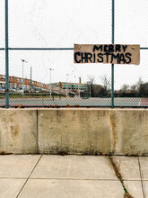 Spray Painted Merry Christmas Sign On Fence In The City