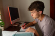 © Erin Brant/Stocksy - Teenager with cochlear implant at desk