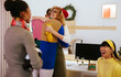 © BONNINSTUDIO/Stocksy - Cheerful colleagues celebrating Christmas in workplace