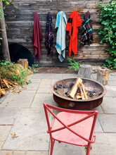 Blankets Hang On Wooden Wall Next To Outdoor Fireplace