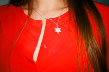 Girl With A David Star Neckless And A Red Blouse