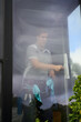 © Rowena Naylor/Stocksy - Window cleaner working inside home