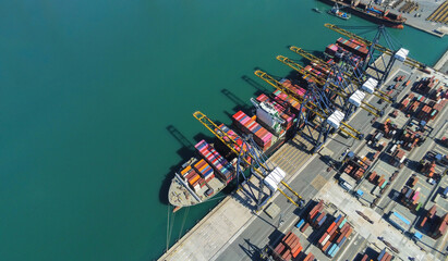 Aerial top view containers ship cargo business commercial trade logistic and transportation of international import export by container freight cargo ship in the open seaport.