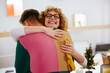 © BONNINSTUDIO/Stocksy - Happy woman hugging male colleague