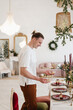© Alina Hvostikova/Stocksy - Man serving table for Christmas dinner