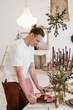 © Alina Hvostikova/Stocksy - Man serving table for Christmas dinner