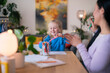© Studio Marmellata/Stocksy - Girl and nanny talking while drawing
