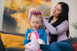 © Studio Marmellata/Stocksy - Nanny braiding combing hair of girl
