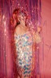 © Liliya Rodnikova/Stocksy - Cheerful woman playing with tinsel