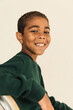 © Anna Tabakova/Stocksy - Little black boy smiling happily in studio