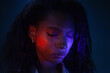 © Anna Berkut/Stocksy - female portrait with closed eyes in neon light