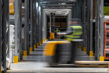 Workers On Forklifts In Motion 