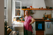 © Jimena Roquero/Stocksy - Elderly woman in the kitchen looking at camera