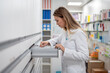 © Bisual Studio/Stocksy - Pharmacist searching medicine in drawer
